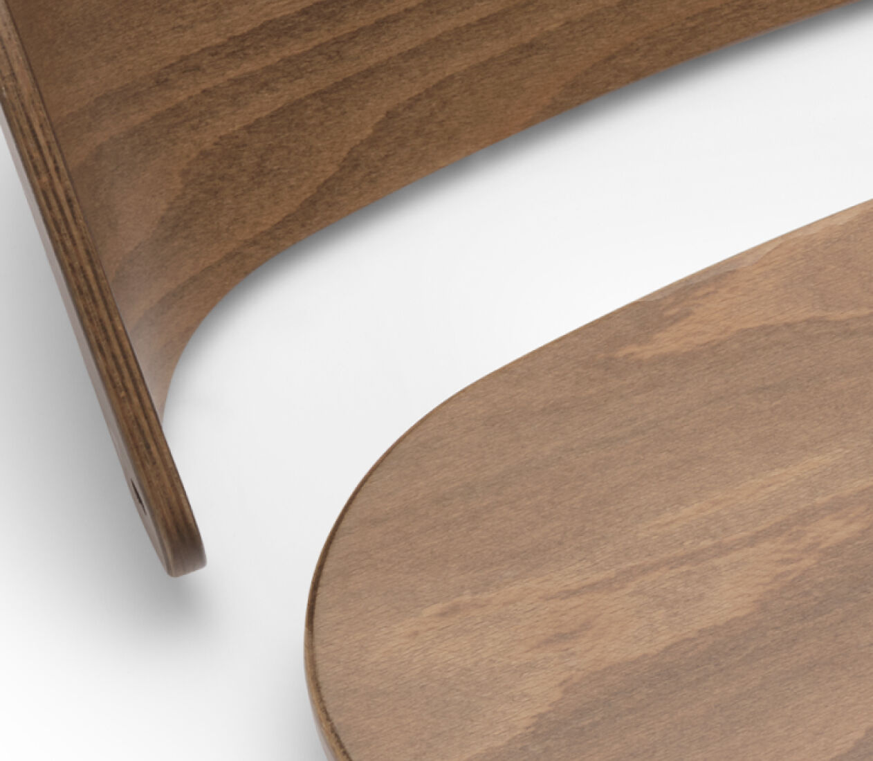Close up on a Bugaboo chair's wooden backrest and seat.