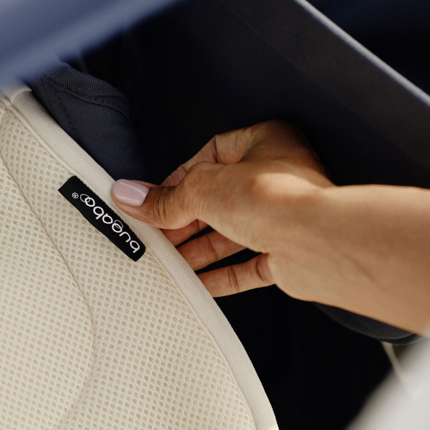A Bugaboo expert checks the fabric on a seat inlay.