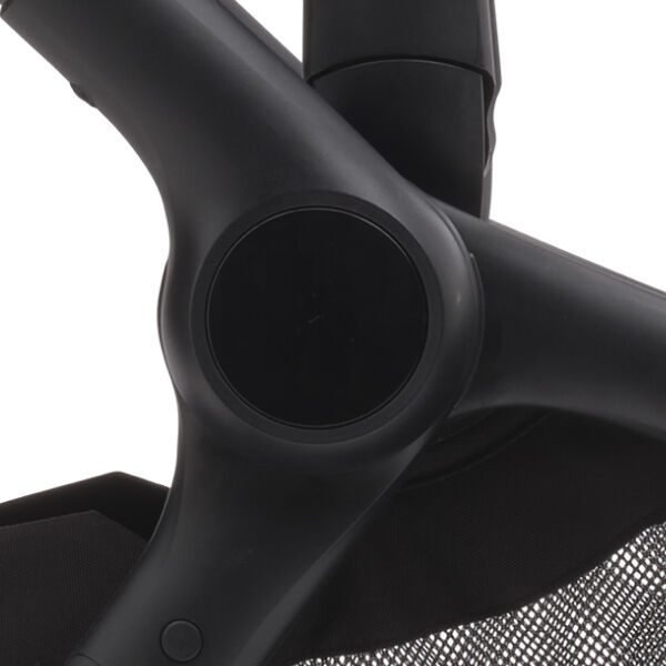 Close up on a Bugaboo stroller's chassis with a sleek finish and a matte, black central button.