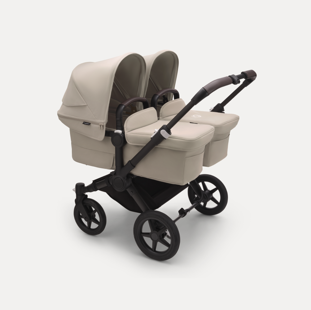 A Bugaboo Donkey 5 Twin stroller with two bassinets, in Desert Taupe colorway.