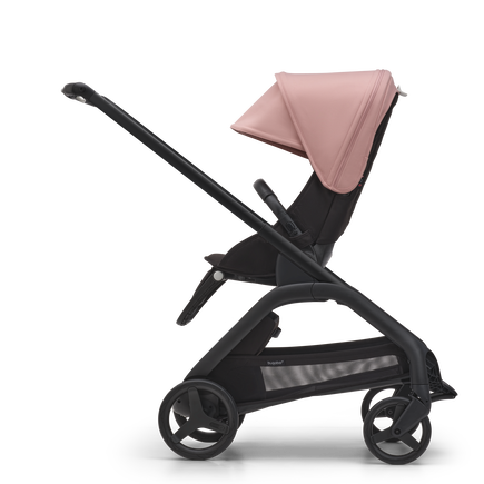 Side view of the Bugaboo Dragonfly seat stroller with black chassis, midnight black fabrics and morning pink sun canopy. - view 2