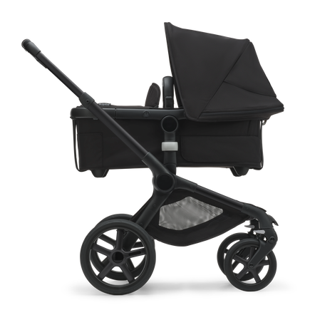 Side view of the Bugaboo Fox 5 bassinet stroller with black chassis, midnight black fabrics and midnight black sun canopy. - view 2